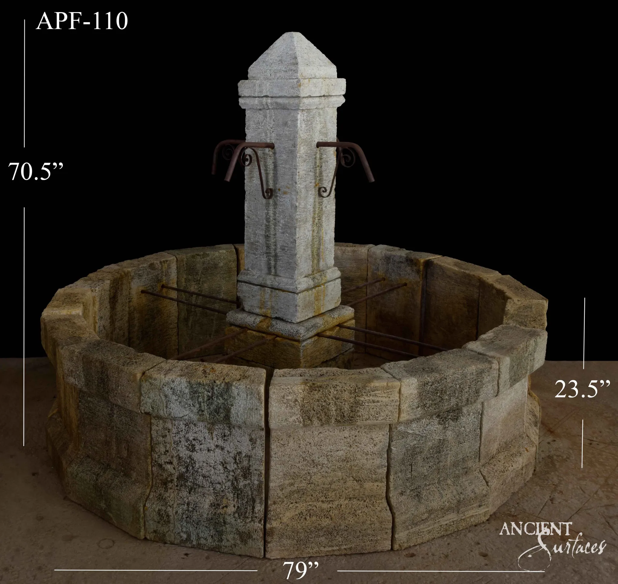 Reclaimed antique limestone round basin fountain from Ancient Surfaces, catalogued as APF 110, built from quarry faced stone blocks with a pyramid capped pedestal, photographed against black with dealer measurements of 79 inches diameter